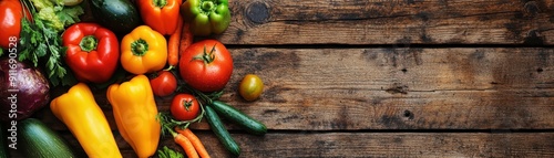 A colorful assortment of fresh vegetables on a rustic wooden surface, including bell peppers, tomatoes, and zucchinis. Perfect for a healthy diet.