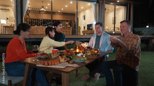 Family holding sparkler in holiday celebration dinner party. Family member enjoy play spark together. Outdoor activity spending time with toy cross generation gap strengthen family bond. Divergence.