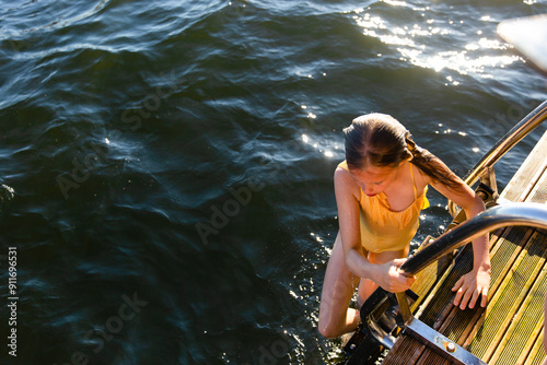 A girl jumps into the fjord in Oslo photo