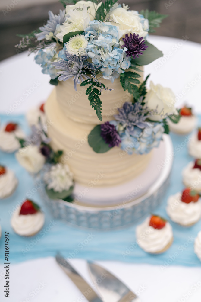 wedding cake with cupcakes at wedding reception wedding cake with cupcakes at wedding reception