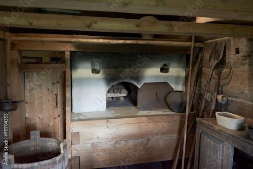 an old stove in a wooden hut