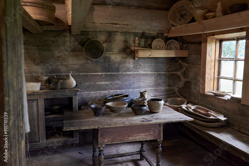 A cozy log cabin kitchen with a table and chairs for dining