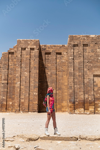 Woman adventurer at Step Pyramid complex entrance, travel lifestyle photo