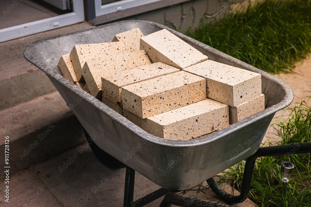 construction works, fireclay bricks are placed on a construction wheelbarrow construction works, fireclay bricks are placed on a construction wheelbarrow