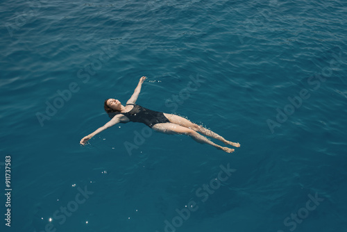 Woman resting on water with outstretched arms