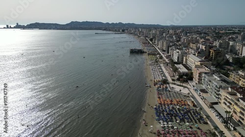 View of Durres coast, Aerial drone footage of sea waves reaching shore in the coast. Sunny day coastline, Adriatic Sea, Albania, Europe photo