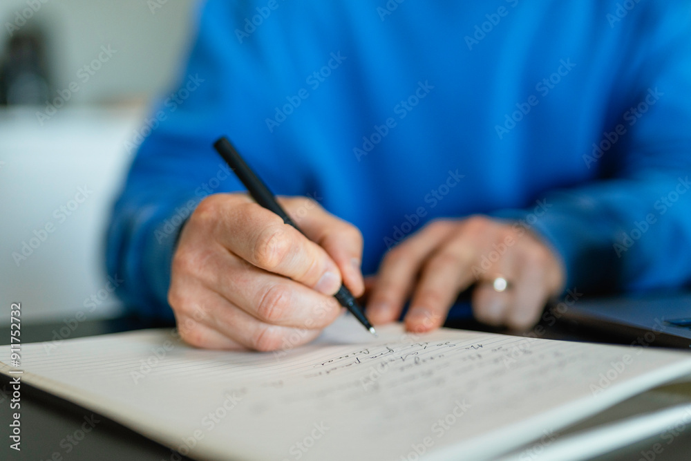 A man writes in a notebook A man writes in a notebook