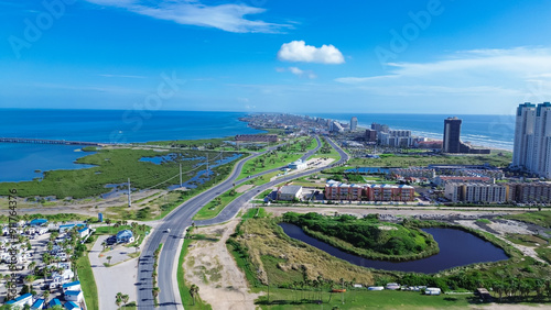 Beach RV park and camping site along State Park Road 100 near downtown South Padres Island, high-rise condos, beach-front hotels, white sandy beaches turquoise water, calm waves, aerial view