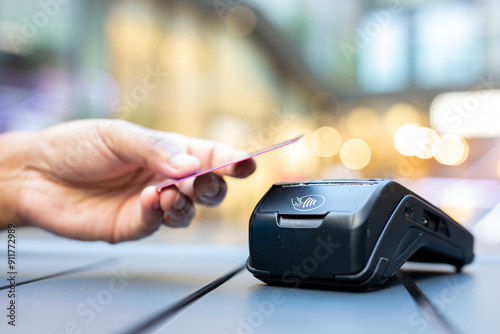 Man Using Credit Card at Checkout