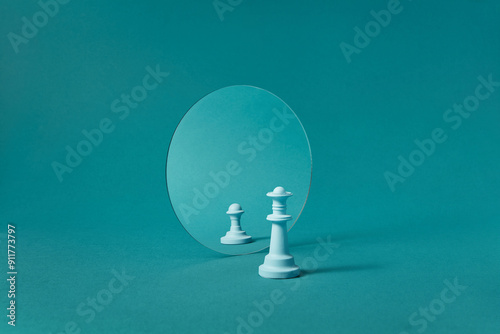 White chess queen against mirror with reflection of pawn