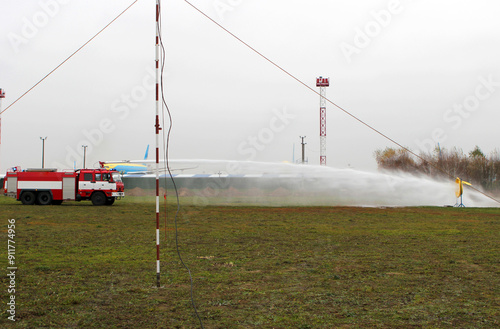 Slika na platnu Fire engine with water spraying at an airfield