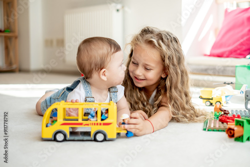 Brother and sister playing together, girl spending time with sibling, teaching him to explore life, cuties photo