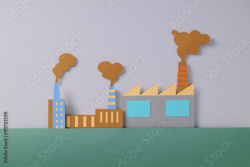 Paper Art Factory Emitting Smoke with Colorful Chimneys photo