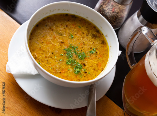 Bild auf Leinwand Appetizing Czech hot soup Polevka with vegetables and egg garnished with greens