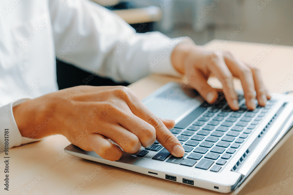 Businessman hand typing on computer keyboard of a laptop computer in office. Business and finance concept. uds Businessman hand typing on computer keyboard of a laptop computer in office. Business and finance concept. uds