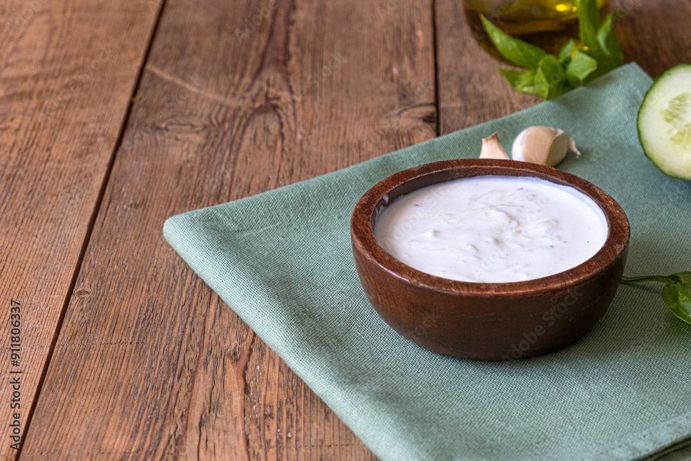 White dip sauce - sour cream or yogurt in wooden bowl. Greek sauce White dip sauce - sour cream or yogurt in wooden bowl. Greek sauce