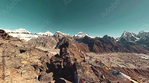 360 VR Gokyo Ri mountain top. Tibetan prayer Buddhist flag. Wild Himalayas high altitude nature and mount valley. Rocky slopes covered with snow. Panorama camera movement.