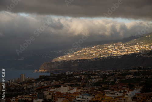 Sun trough clouds in village