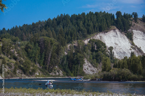 Beautiful summer scenery on the river, people go boating for fishing or for fun, swimming and having a nice afternoon, on the Snake River in Wyoming. photo