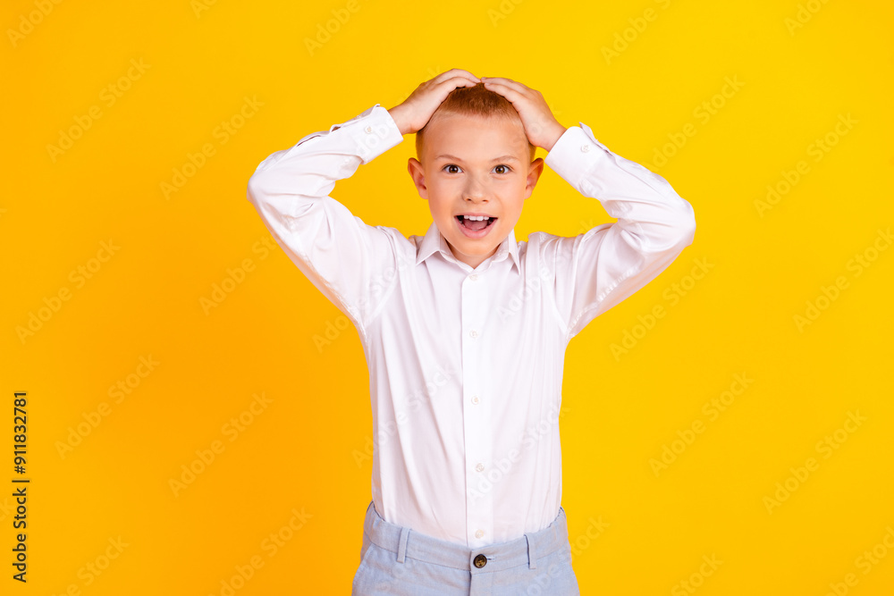 Photo of charming shocked clever nice boy wear white shirt clothes hand head isolated on yellow color background