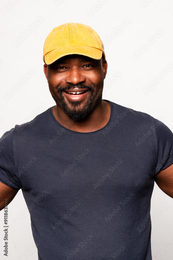 Man smiling with yellow cap, wearing navy blue t-shirt Man smiling with yellow cap, wearing navy blue t-shirt