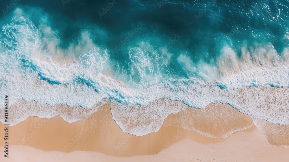 Obraz premium Panoramic shot of a sandy shoreline with waves rolling in softly, offering a peaceful and expansive beach view.