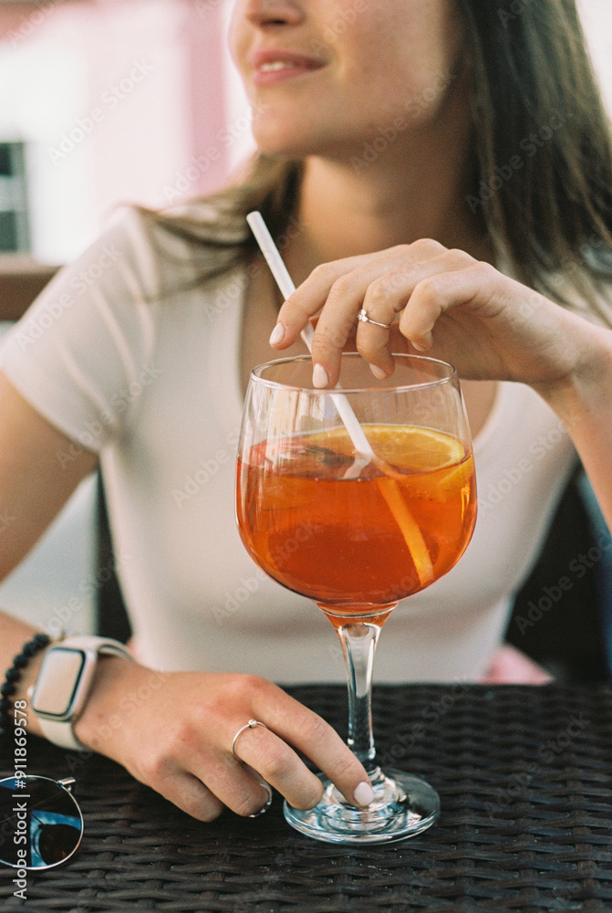 Woman with aperol spritz with drinking straw Woman with aperol spritz with drinking straw
