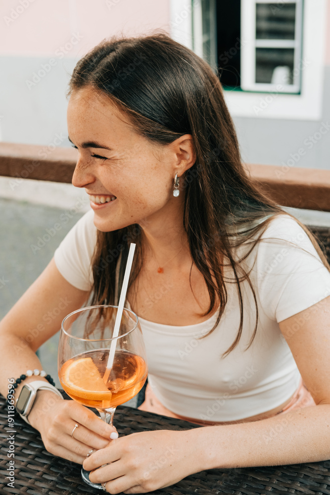 Woman laughing while having aperol