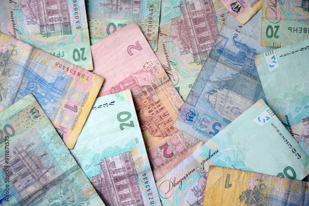 Obraz premium Processed collage of Ukrainian Hryvnia UAH bills banknotes texture. Background for banner