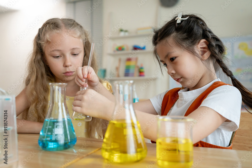 Two young student girls learning in classroom at elementary school. Two young student girls learning in classroom at elementary school.