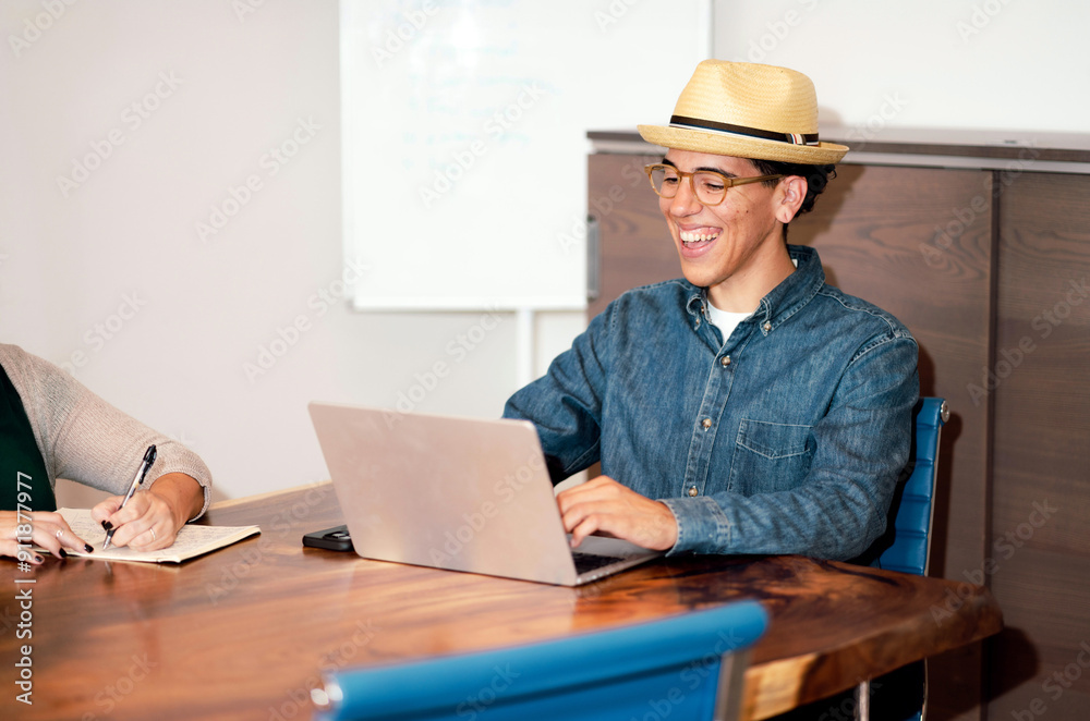 Female Laughing During Project Planning with Co-Worker Female Laughing During Project Planning with Co-Worker