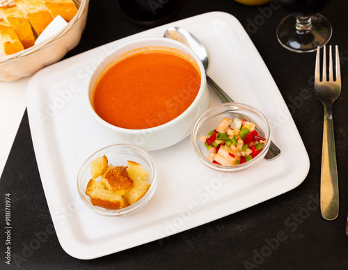 Gazpacho in glass spanish tomato based cold vegetable soup served with cucumbers and baked bread