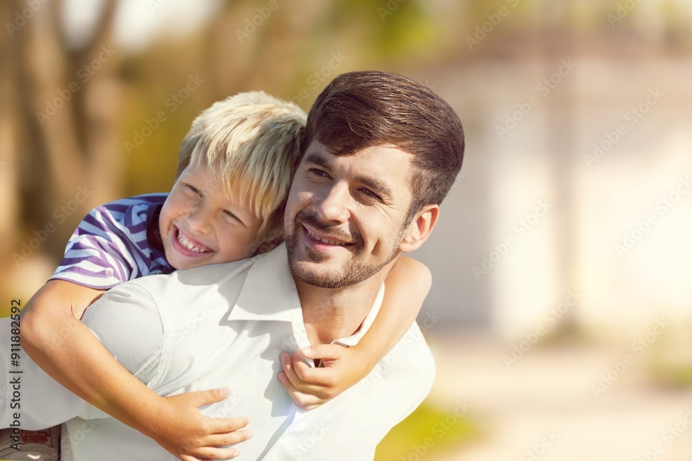 Fototapeta premium Happy young father with son having fun
