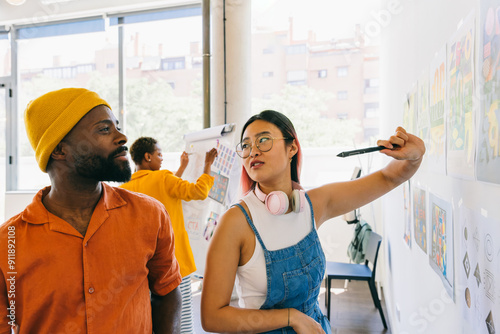 Creative team collaborating on project in bright modern office space