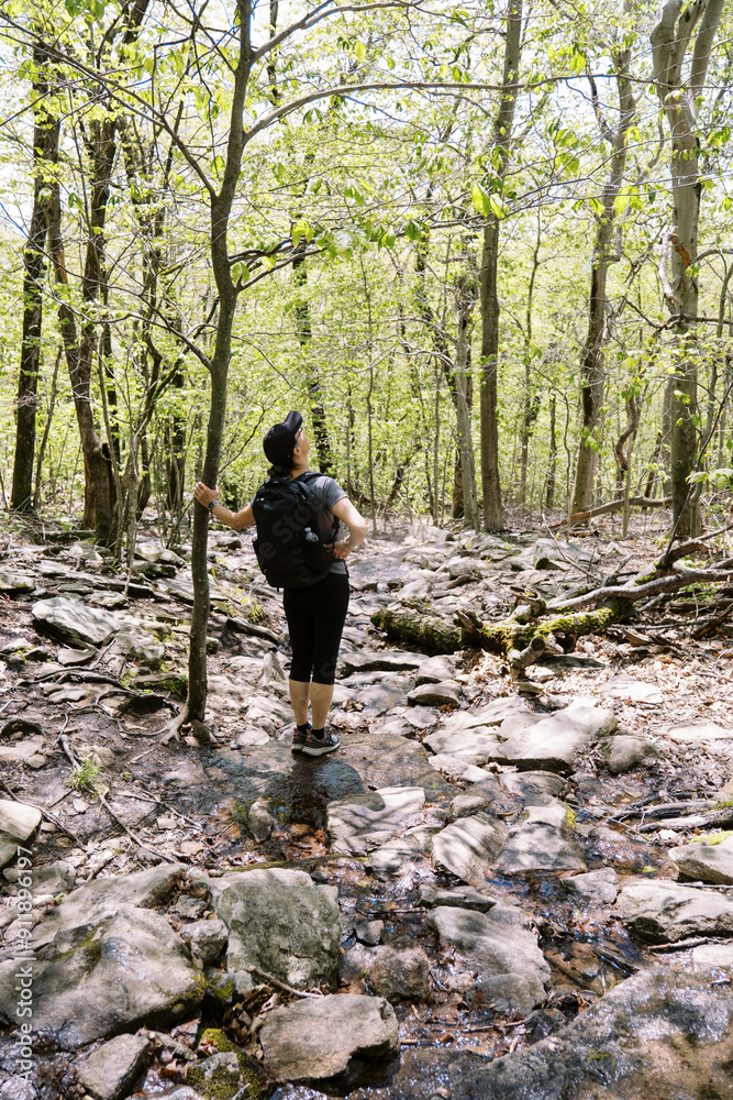 woman on a hike in central Massachusetts, the trail is made of rocks