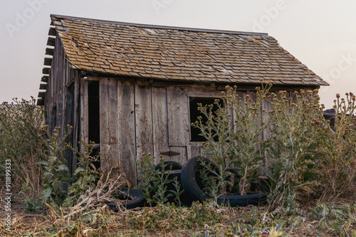 Abandoned farm ruins with barns and agriculture equipment in the Colorado prairies