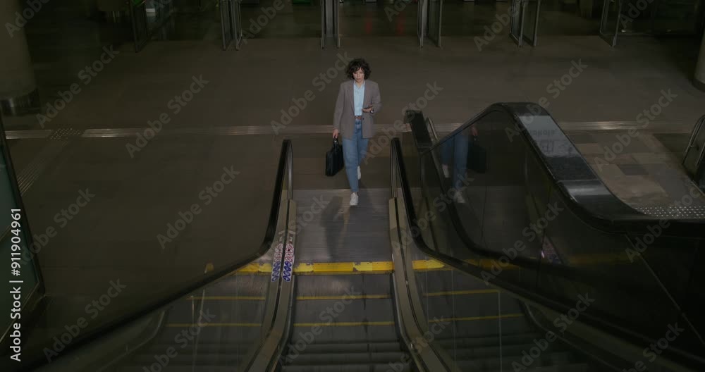 custom made wallpaper toronto digitalA woman in casual clothes uses a mobile phone when riding an escalator up. She's coming up from the subway station
