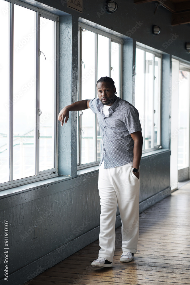 Man leans in natural light by window Man leans in natural light by window