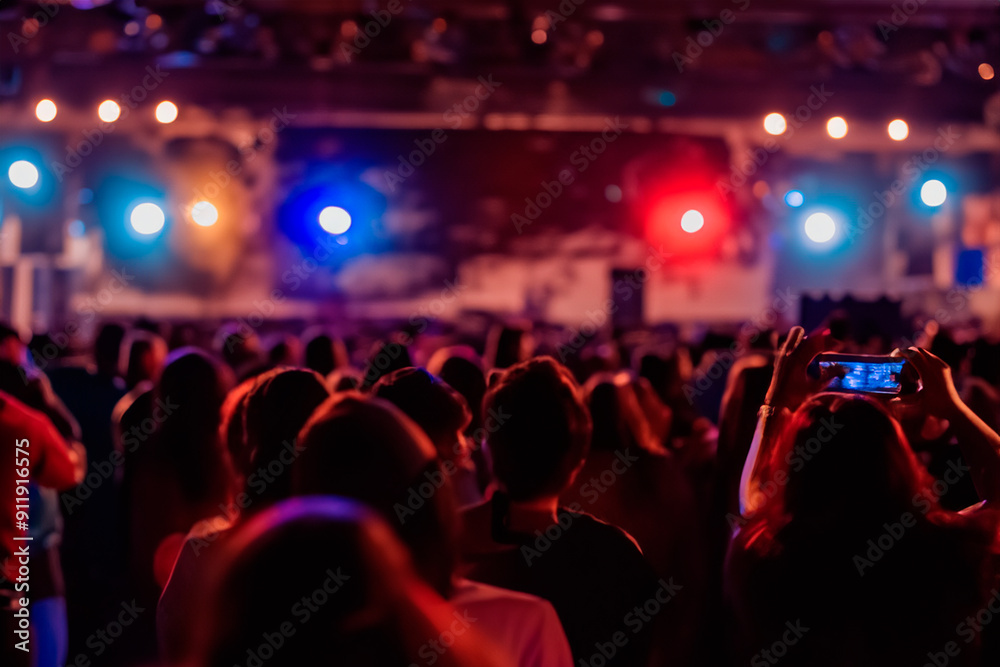 People celebrating at a night concert People celebrating at a night concert