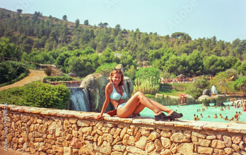 portrait with anological film of teenager in the pool having fun photo