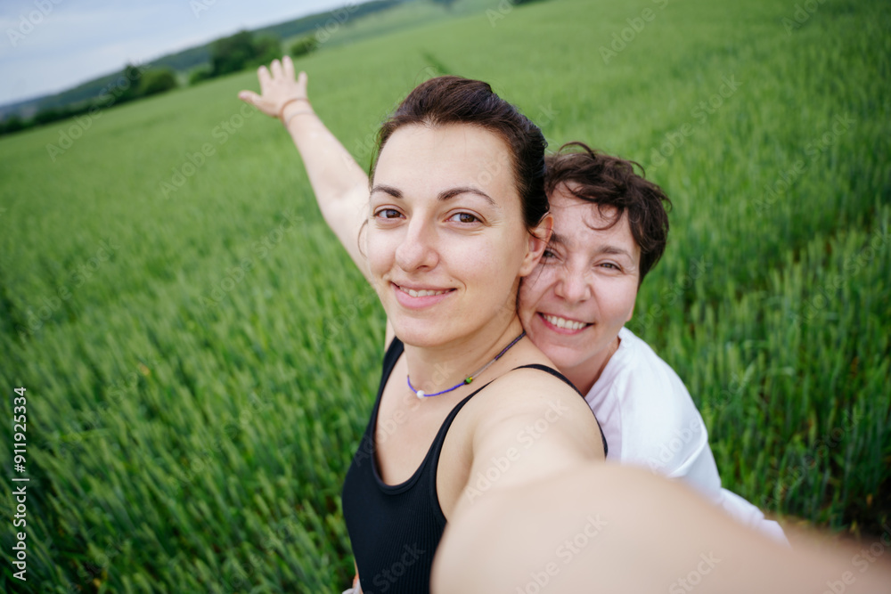 Couple of women in a field portrait selfie Couple of women in a field portrait selfie