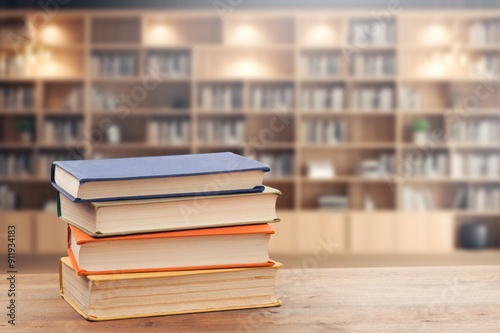 stack of reading books on desk in library