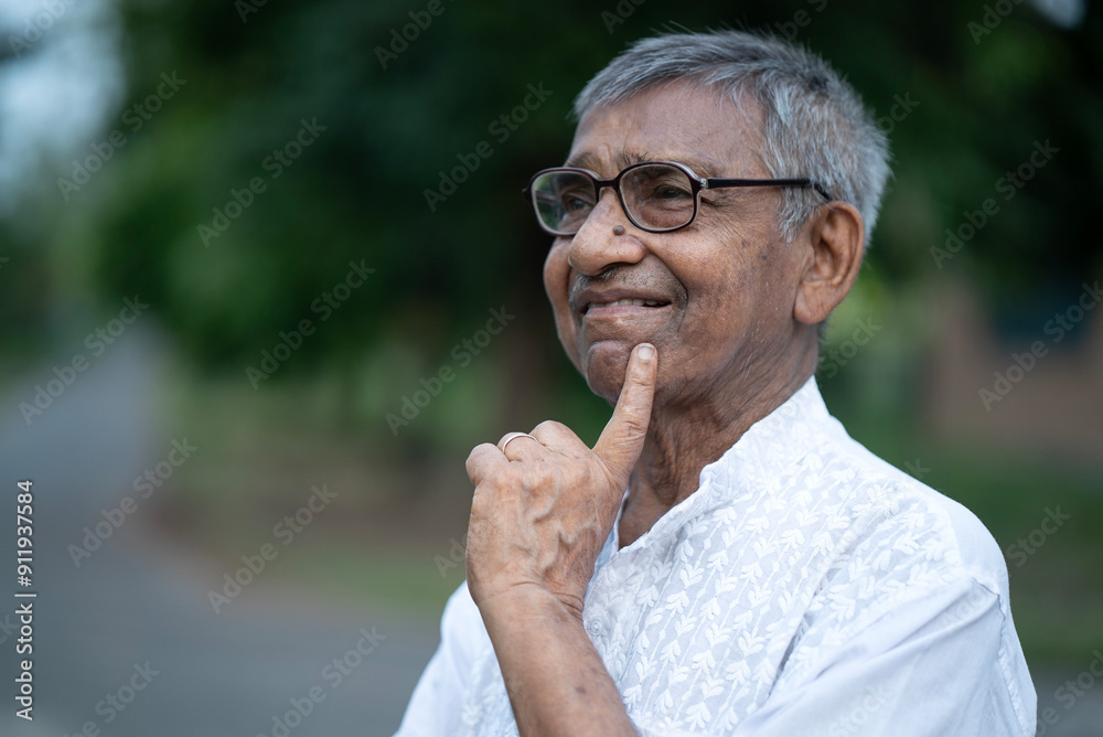 Portrait and facial expression of an Indian aged man at outdoors Portrait and facial expression of an Indian aged man at outdoors