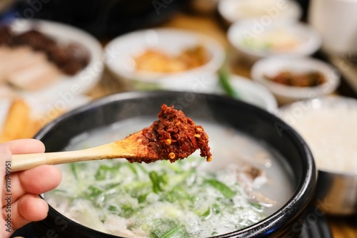 Korean chilli paste (dadaegi), that used as a condiment in gukbap (soup with rice), such as this pot of soondae gukbap (blood sausage soup) with steamed rice and assorted banchan at Yeodongsik photo