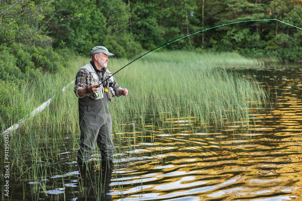 Fisherman Standing in Lake Amidst Scenic Wilderness Fisherman Standing in Lake Amidst Scenic Wilderness