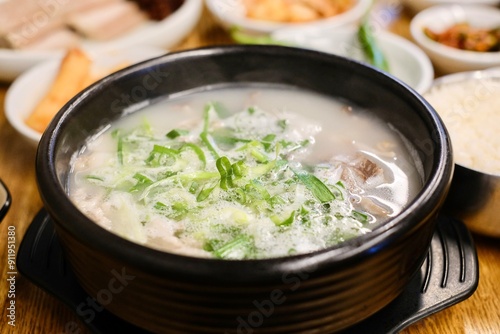 A clay pot of soondae gukbap (blood sausage soup) with steamed rice and assorted banchan, such as kimchi, at Yeodongsik - a Korean restaurant in Sydney, Australia  photo