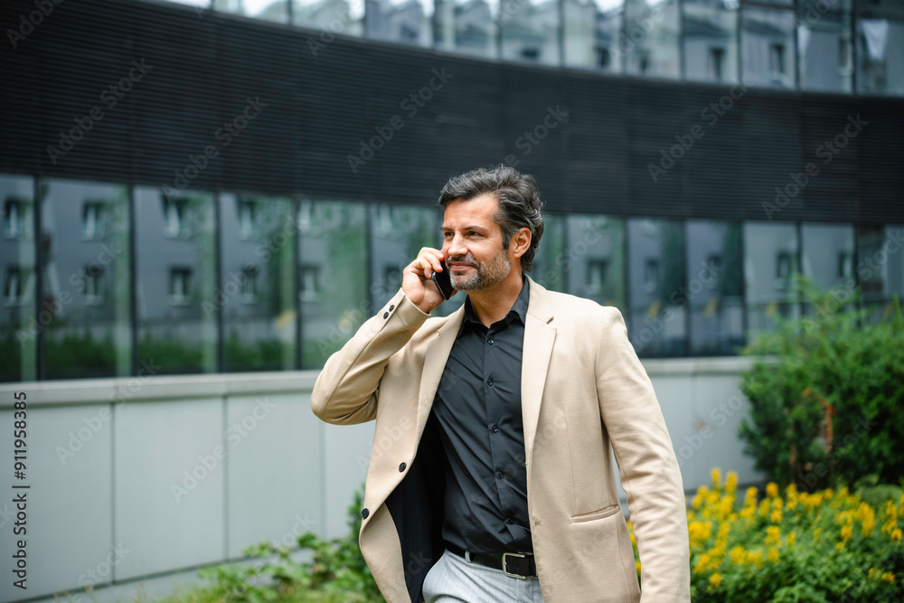 A man is talking on a mobile phone in the city A man is talking on a mobile phone in the city