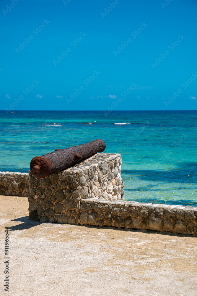 Rusty Colonial Cannon Pointing to the Caribbean Sea in Sunny Akumal Rusty Colonial Cannon Pointing to the Caribbean Sea in Sunny Akumal