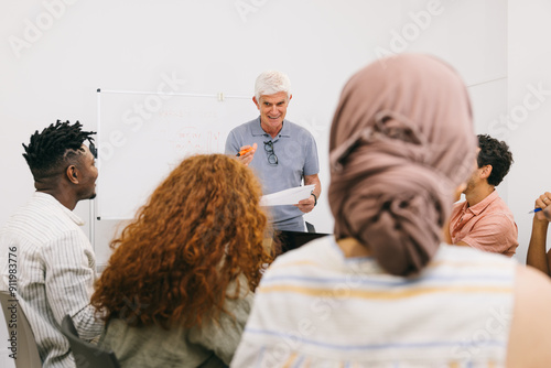 Instructor giving presentation to diverse group of adult learners