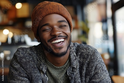 young African American hipster man laughing with a wide infectious smile